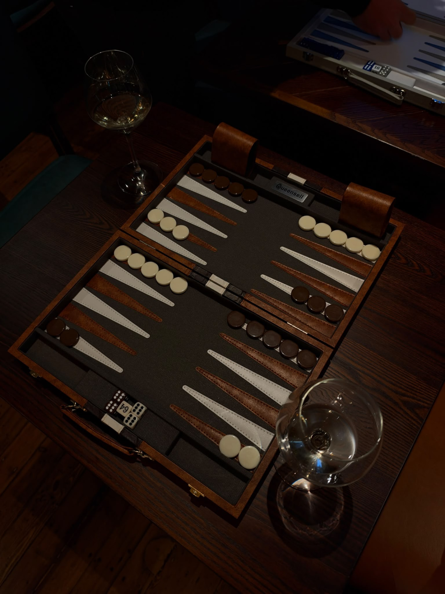Backgammon boards and glasses of wine at an event