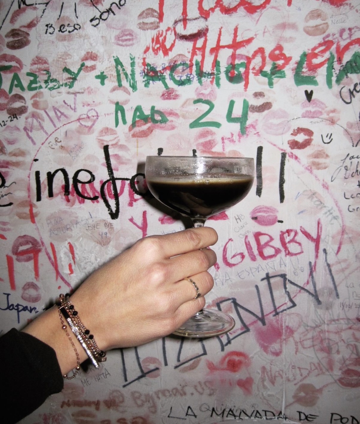 A cocktail in front of Macera's signed wall